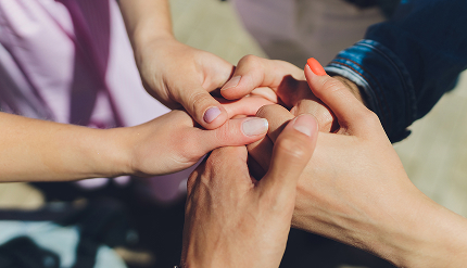Multiple people holding hands